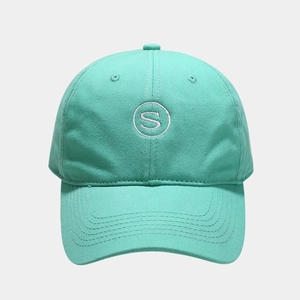 Detail of mint green baseball cap featuring white S letter embroidery and cotton twill fabric