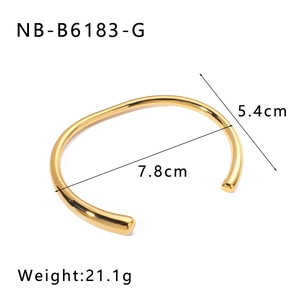 Detail view of gold C-shaped stainless steel bangle with dimensions 7.8cm by 5.4cm