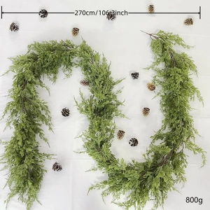 Close-up of 270cm green artificial Christmas cedar garland with pine cones on white background