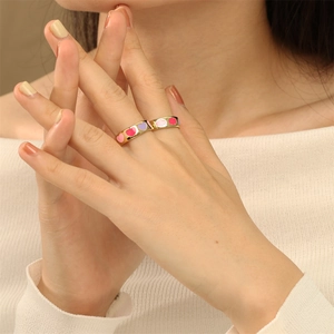 Retro gold plated copper rings with colorful enamel heart charms worn on fingers