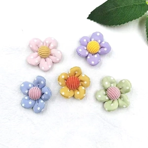 DIY fabric flowers with colorful polka dots and corduroy center for hair accessories