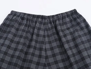 Detail of elastic waistband and textile texture on black and grey plaid casual pants