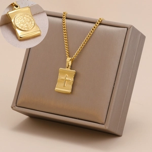 Detailed view of a gold-plated stainless steel cross necklace with a Benedictine medal.