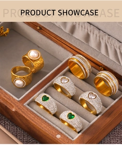 Close-up of gold-plated rings with pearls and zircon in a velvet jewelry box display