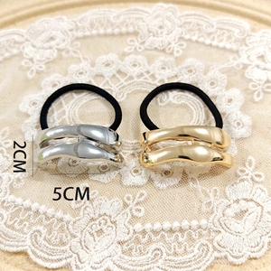Detailed size view of wave-textured alloy ponytail cuff in gold and silver finish