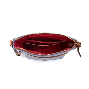 Detailed interior of blue pebble leather crossbody bag with red lining and compartments