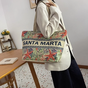 Detail of Santa Marta linen tote bag featuring colorful starfish pattern and double handles