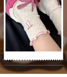 Detail of beige crew sock with pink bow embroidery and ruffled edge for girls
