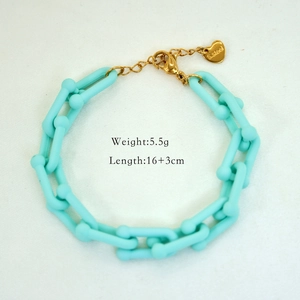 Detail of light blue U-link bracelet in stainless steel with a small heart charm