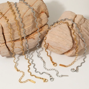 Elegant twisted rope chain necklace set in gold and silver stainless steel on rocks