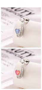 Detail of heart opal J-shaped earrings with cubic zirconia stones in silver titanium steel