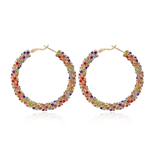 Detail of large gold hoop earrings encrusted with vibrant colorful sparkling rhinestones