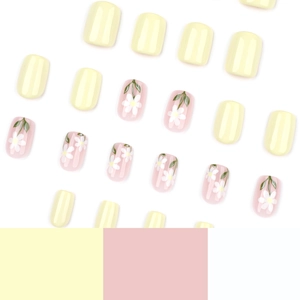 Short square press-on nails featuring bright yellow and pink floral daisy patterns