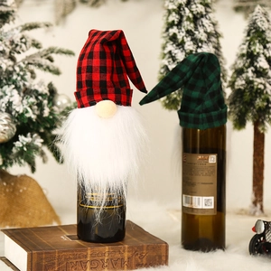 Macro view of Christmas gnome wine bottle covers with red and green plaid hats