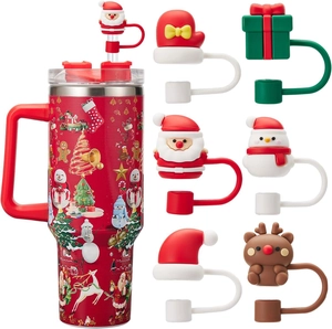 Christmas 40oz tumbler with Santa silicone straw covers and festive holiday patterns