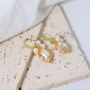 Vintage freshwater pearl earrings with purple crystal tassels and gold leaf detailing