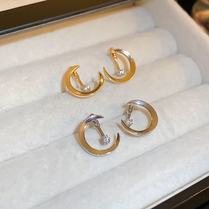 Elegant gold and silver moon earrings with sparkling zircon studs in a velvet jewelry box