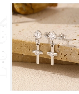 Detail of S925 sterling silver cross earrings with shimmering zircon crystal settings