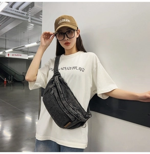 Detail view of vintage washed denim chest bag worn by model in streetwear setting