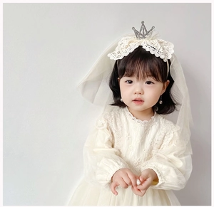 Detailed view of girls' white lace headband with a crown and elegant pearl mesh veil