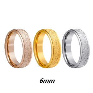 Detailed view of 6mm matte frosted stainless steel rings in rose gold, gold and silver