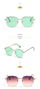 Detailed close-up of polygon gold metal frames with green and pink gradient lenses