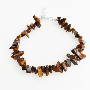 Detail of tiger eye stone bracelet with irregular polished beads and adjustable lobster clasp