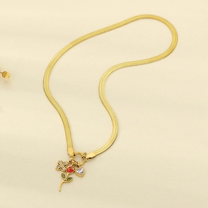 Detail of gold snake chain with red enamel rose, heart zircon and flower charms