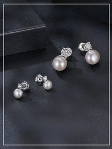 Macro shot of S925 sterling silver stud earrings with 0.5ct moissanite and natural pearl