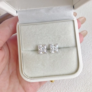 Detailed macro view of S925 sterling silver square-cut zircon studs in a velvet box