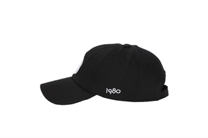 Detailed side view of black baseball cap featuring white 1980 embroidery on cotton fabric