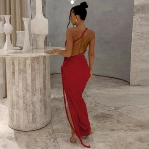 Detail of cross-strapped backless design on a deep red slim-fit maxi dress
