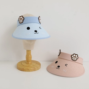 Detail of pink and blue kids straw sun hats featuring cute cat embroidery and ear accents