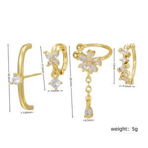 Detailed view of 18k gold plated flower and butterfly earrings with cubic zirconia stones