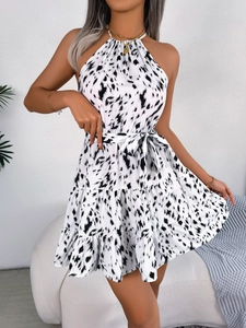 Detail of leopard print halter neck dress with gold chain necklace and matching waist belt