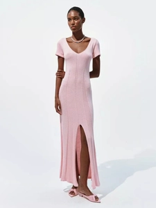 Detail of pink knitted V-neck dress featuring short sleeves and a stylish side slit hem