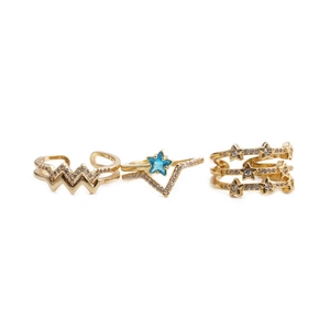 Three-piece golden minimalist ring set with wave patterns and blue star-shaped gemstones
