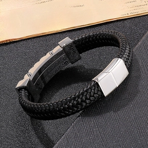 Detailed shot of men's black braided leather bracelet with polished silver metal clasp