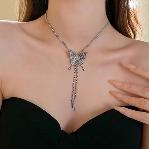 Silver butterfly pendant necklace with elegant tassels shown on a model neck