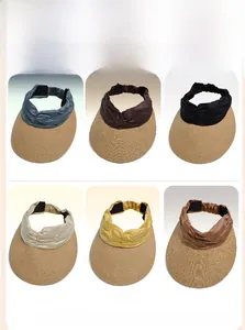 Detailed view of woven wide-brim sun hats in blue, coffee, black, cream, yellow, and khaki