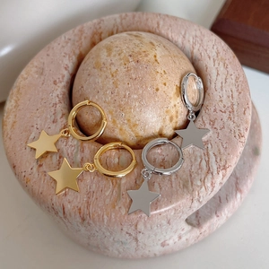 Detailed macro shot of S925 sterling silver stamp on gold and silver star earrings