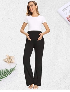 Close-up of high-waisted black maternity pants in soft elastic knitted cotton fabric
