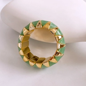 Detailed close-up of vintage branch texture gold and green resin bangle bracelet