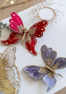 Detail of glittered velvet Christmas butterfly ornaments with sequins and rhinestone clips