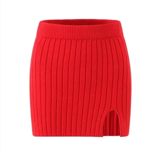 Detailed view of red ribbed knit mini skirt featuring a sexy side slit and elastic waist