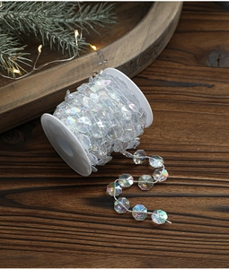 Iridescent octagonal beaded chain on white spool for Christmas tree decoration