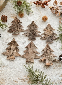Detailed close-up of Christmas tree bark ornaments with pine cones on artificial snow