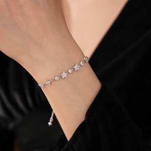 Detailed view of silver star bracelet with sparkling zircon stones on a model wrist