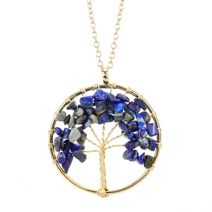 Detail of handmade gold wire-wrapped Tree of Life pendant with blue lapis stones