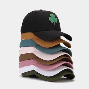 Breathable clover baseball caps stacked in eight colors including black, yellow, and green